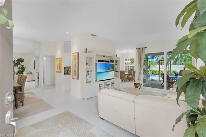 Living area featuring light tile patterned floors and recessed lighting