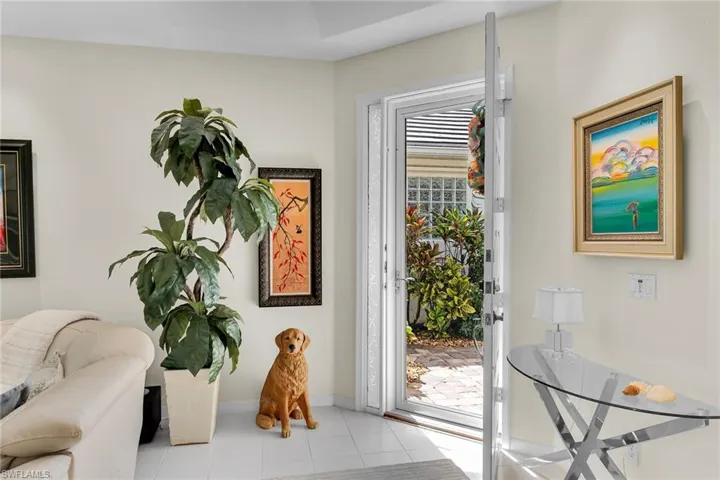 Doorway featuring tile patterned flooring and baseboards