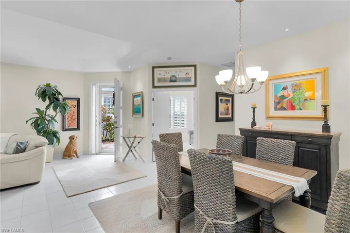 Dining area featuring suspended lighting and light tile patterned floors