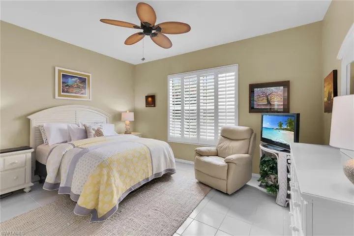 Bedroom featuring light tile patterned flooring and a ceiling fan