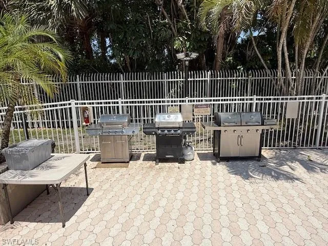 View of patio with a grill