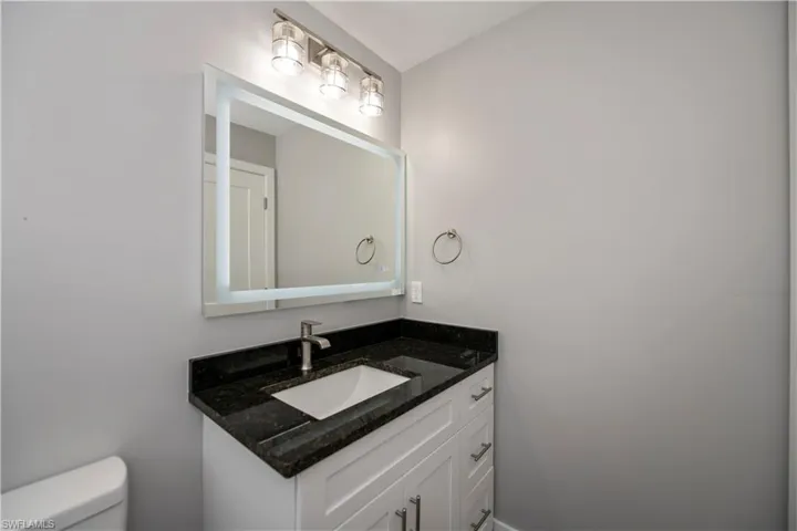 Half bath with vanity and toilet