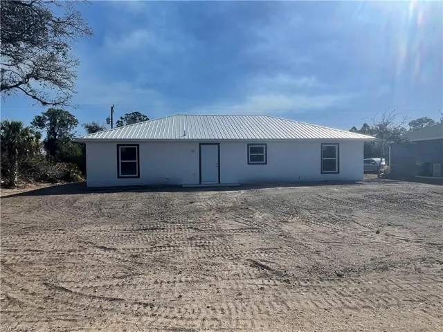 Back of property with a metal roof