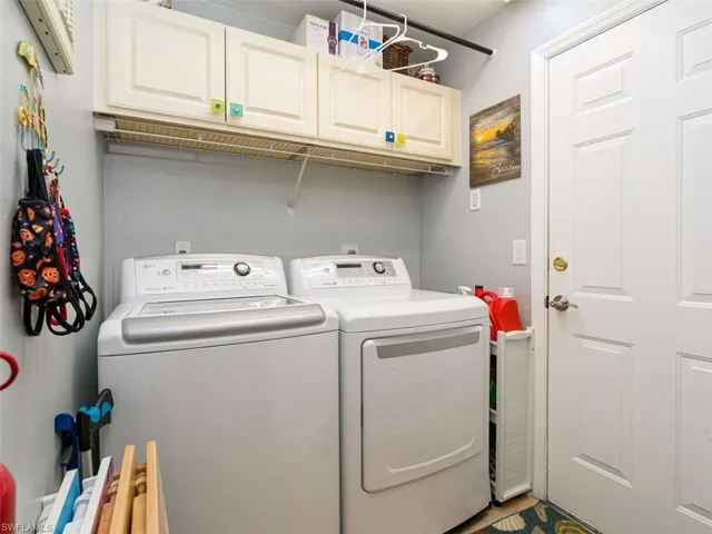Laundry room with cabinets and separate washer and dryer
