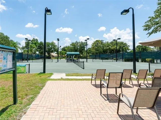 View of sport court with a yard