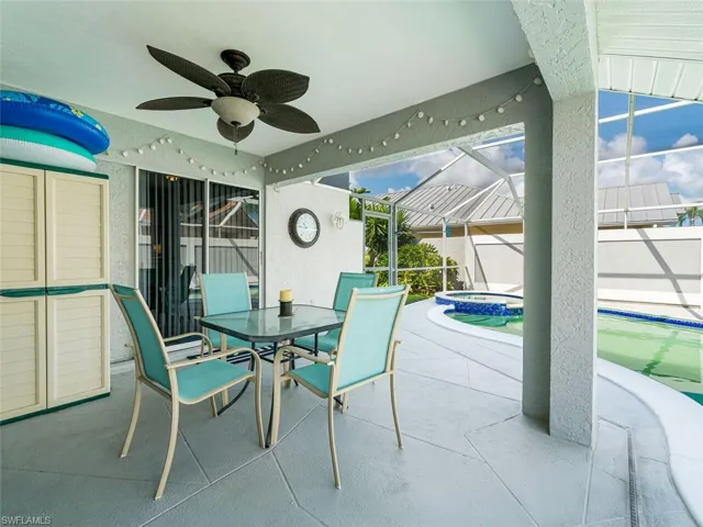View of terrace with ceiling fan and a lanai