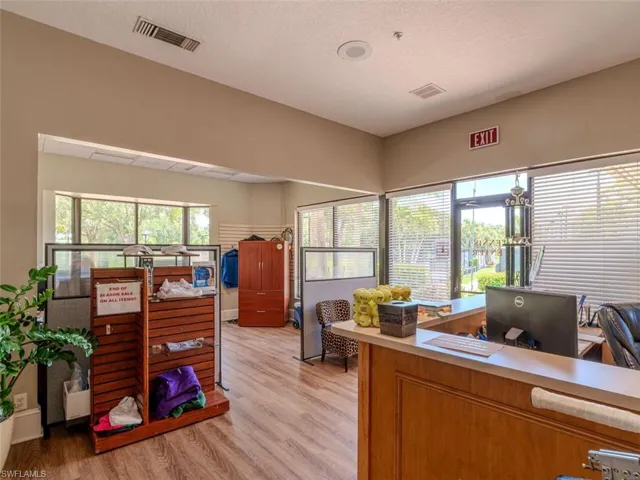 Office area with light hardwood / wood-style floors