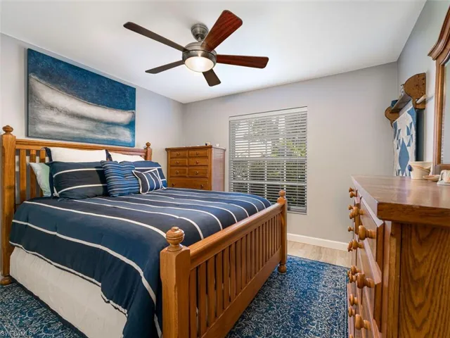 Bedroom featuring ceiling fan and wood-type flooring