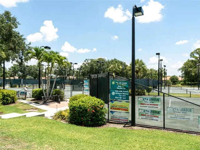 View of nearby features with a yard and tennis court