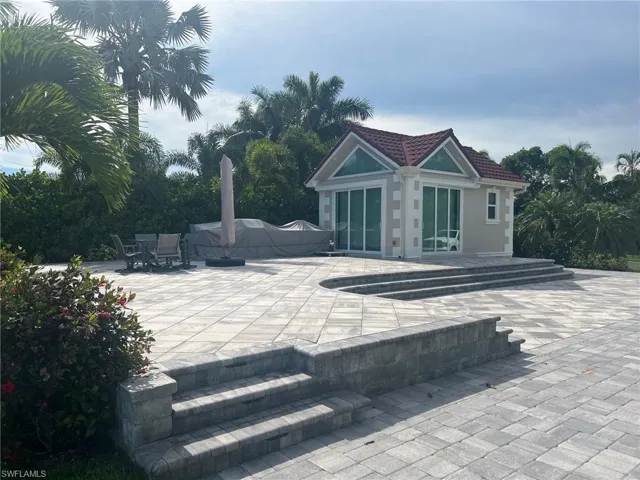 View of patio featuring an outdoor structure, an outdoor pool, and a storage structure