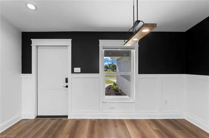 Entrance foyer with hardwood / wood-style floors