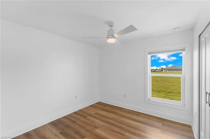 Unfurnished room with wood-type flooring and ceiling fan