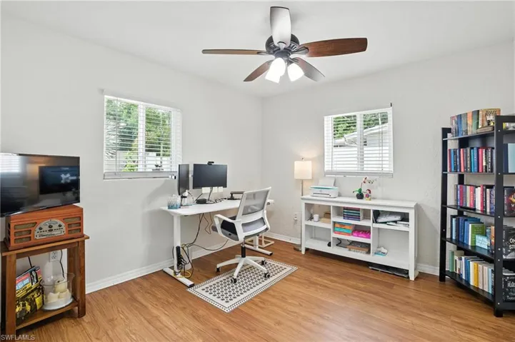 Guest Bedroom or Office Space with wood finished floors, plenty of natural light, and ceiling fan
