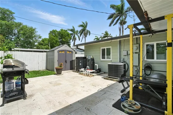 View of patio / terrace with a shed and a grill