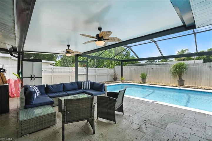 View of pool featuring outdoor lounge area, a patio area, a fenced backyard, and ceiling fan