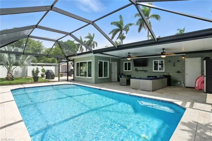 View of swimming pool with an outdoor hangout area, ceiling fan, a patio, and a lanai