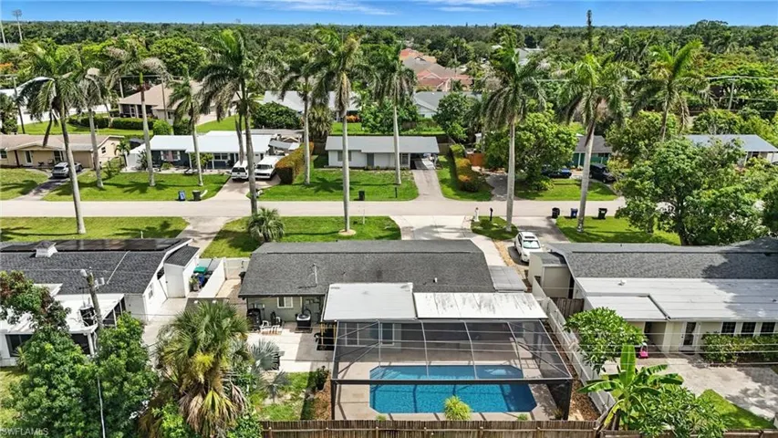 Aerial perspective of suburban area with a pool