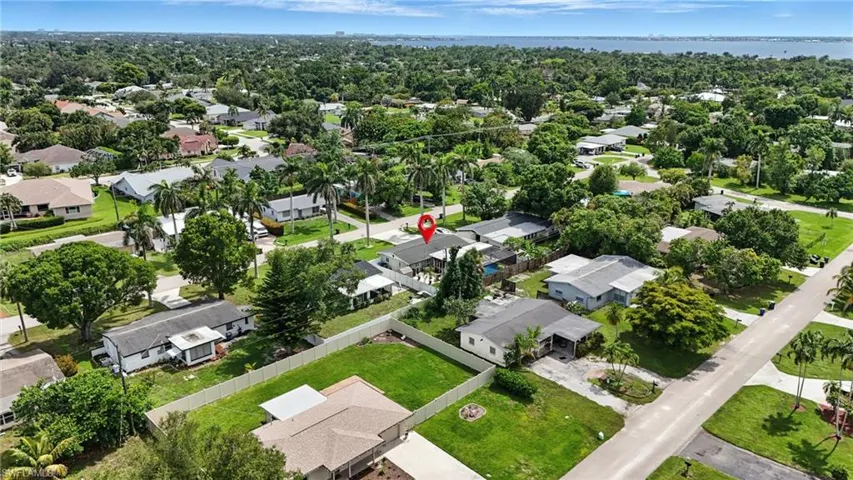 Aerial perspective of suburban area featuring a large body of water