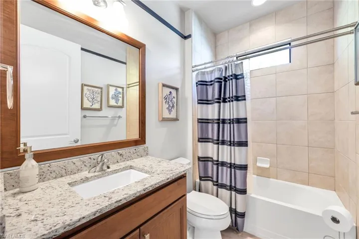 Bathroom with shower / bath combo and vanity
