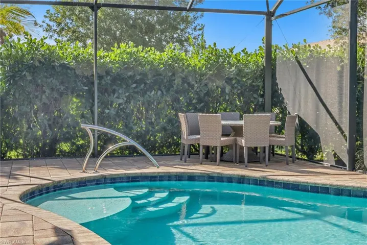 Swimming pool with glass enclosure and a patio