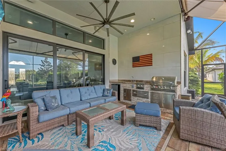 View of patio featuring an outdoor hangout area, ceiling fan, a sunroom, and area for grilling