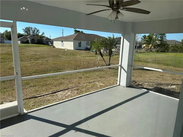 Unfurnished sunroom featuring ceiling fan