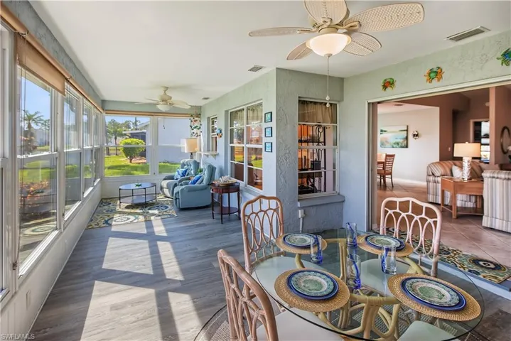 Enclosed sunroom with wood-finish flooring and multiple windows