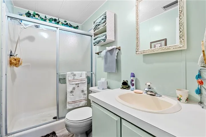 Full bathroom with a shower stall and vanity