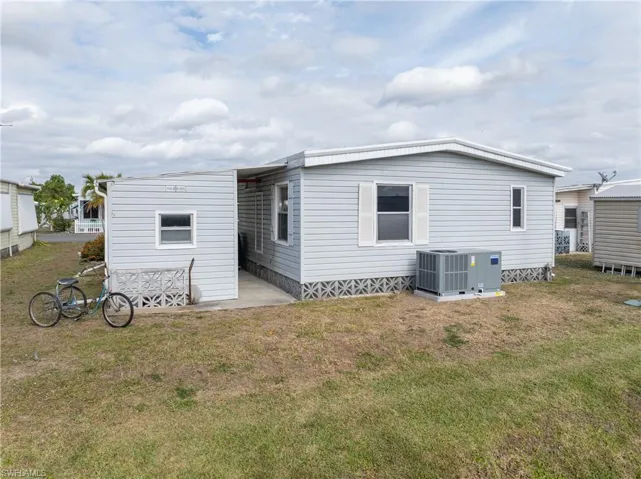 Rear view of property featuring a patio area and a yard