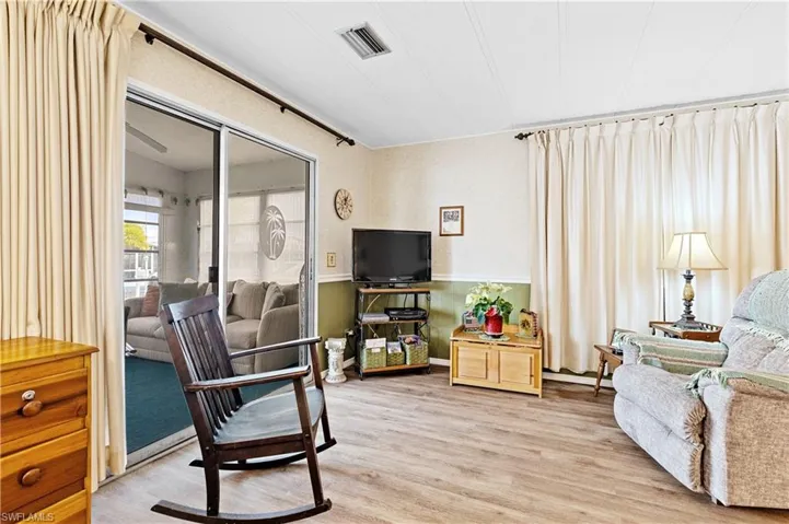 Living area featuring a wainscoted wall and light wood-type flooring