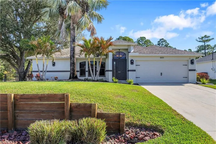 View of front of house featuring a garage, stucco siding, concrete driveway, and a shingled roof