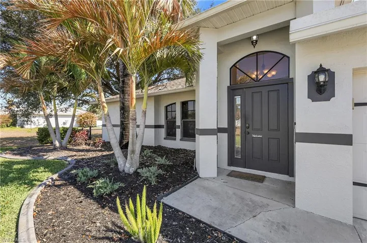View of exterior entry featuring stucco siding