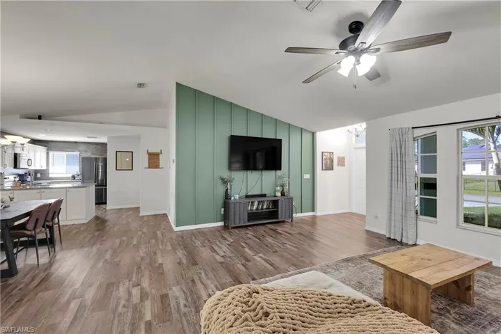 Living area featuring a custom wood finished accent wall.