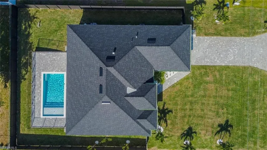 Aerial view of property and surrounding area with a pool