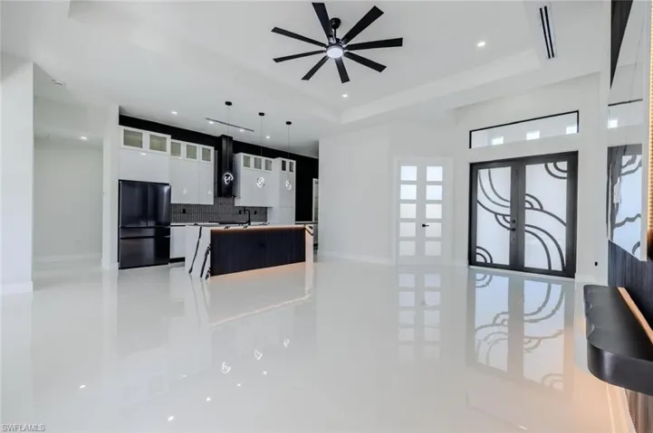 Kitchen featuring french doors, white cabinetry, freestanding refrigerator, modern cabinets, and glass insert cabinets
