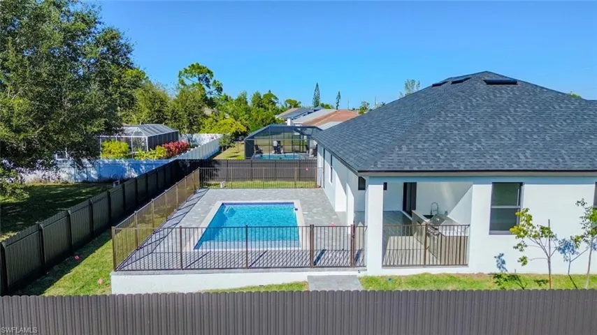 View of pool with a patio and a fenced backyard