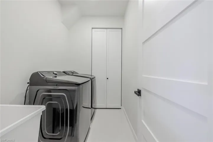 Washroom featuring washer and clothes dryer