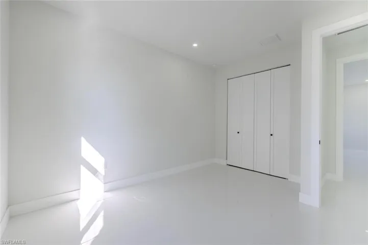 Unfurnished bedroom with recessed lighting and a closet