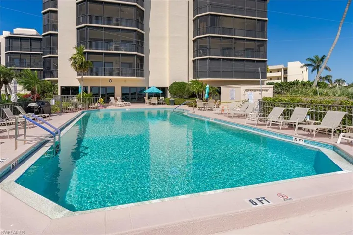 Community pool with a patio and fence