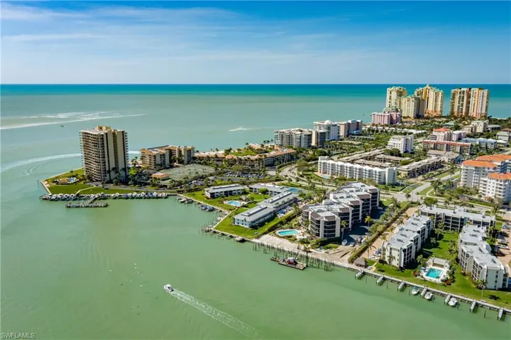 Birds eye view of property with a view of city and a water view