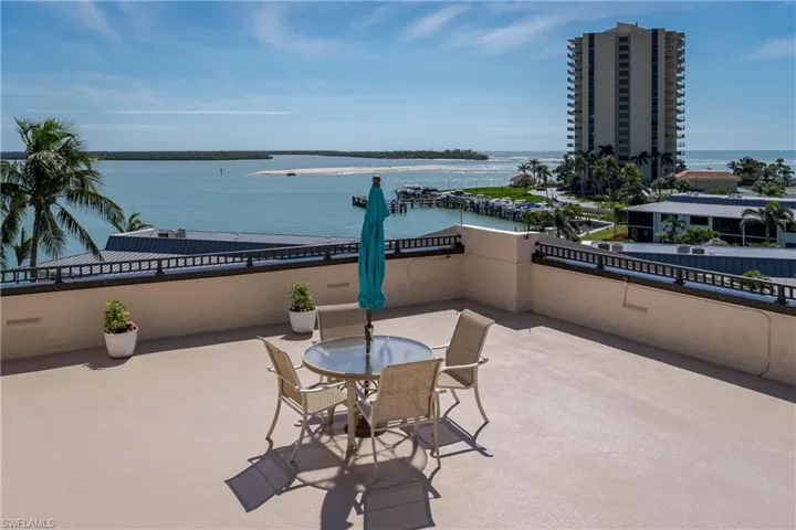 View of patio / terrace with outdoor dining space, a balcony, and a water view
