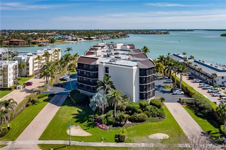 Birds eye view of property with a water view
