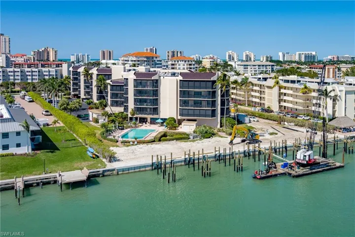 Birds eye view of property with a view of city and a water view