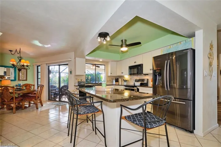 Another view of the kitchen/dining area.  Have you noticed the Sellers have chosen an accent color which flows throughout the home?  Nice touch.