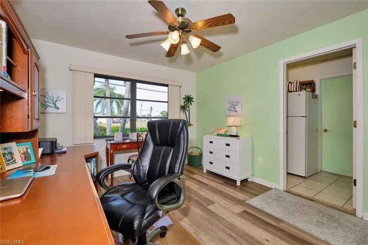Another view of the office.  Door to the right is the laundry room complete with a second refrigerator.  Green door leads to the two-car garage.