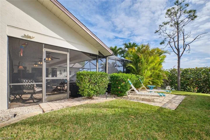 View of yard with a lanai, a patio area, and ceiling fan