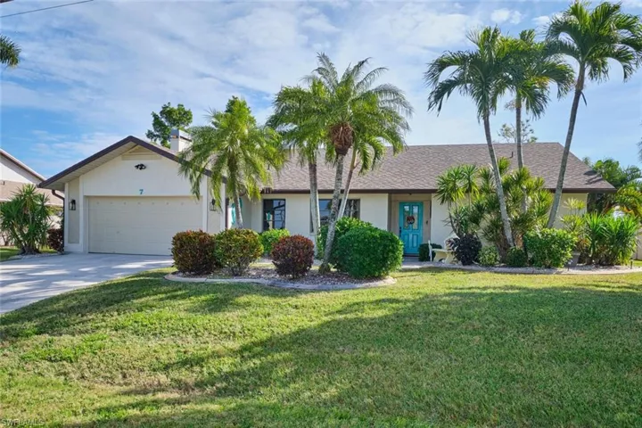 Front view of home.  Nice teal accents, newer roof, two-car air-conditioned garage.  Wait till you see inside!