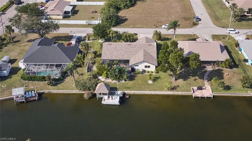 Aerial view of very private back yard.  You can see the 12 X 26 foot boat dock along with the 12 X 12 Tiki Hut.  So may places to relax at in this home.