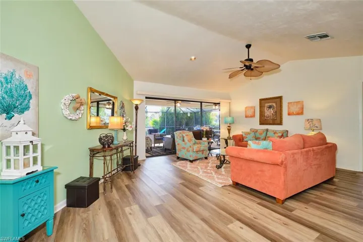 The living room is the first room you see as entering this home.  Triple sliders to the lanai, Tiki and canal.  Volted ceiling is a plus!