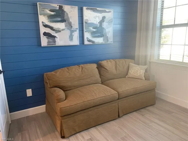 Living area featuring wooden walls and wood finished floors